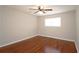 Bedroom featuring hardwood floors, ceiling fan, and natural light from a window at 5415 Keithwood Dr, Cumming, GA 30040