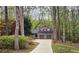 Charming two-story home with brown siding, a two-car garage, and a landscaped front yard surrounded by mature trees at 5415 Keithwood Dr, Cumming, GA 30040
