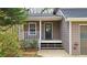 A welcoming front porch with a black door, white railings, and steps, creating a cozy entrance to the home at 5415 Keithwood Dr, Cumming, GA 30040