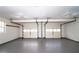 Spacious two car garage featuring white doors and a neutral grey floor at 5415 Keithwood Dr, Cumming, GA 30040