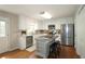 Well-lit kitchen with white cabinetry, stainless steel appliances, a central island, and hardwood floors at 5415 Keithwood Dr, Cumming, GA 30040