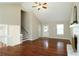 The living room with hardwood floors, a white fireplace, staircase, and a view of the front door at 5415 Keithwood Dr, Cumming, GA 30040