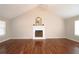 The living room showcases a white fireplace, vaulted ceilings, hardwood floors, and ample space for entertaining or relaxation at 5415 Keithwood Dr, Cumming, GA 30040