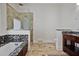 Bathroom features a bathtub with stone accents, large shower, and vanity with granite countertop at 176 Stewart Nw Ave, Marietta, GA 30064
