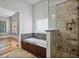 Bathroom featuring tiled shower, granite countertop, vanity, and adjacent bedroom at 176 Stewart Nw Ave, Marietta, GA 30064
