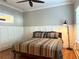 Cozy bedroom features wood floors, a modern ceiling fan, and white paneled walls at 176 Stewart Nw Ave, Marietta, GA 30064