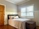 Comfortable bedroom featuring wood floors, a window with blinds, and light gray painted walls at 176 Stewart Nw Ave, Marietta, GA 30064