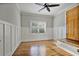 A bright bedroom features wood floors, white-painted paneled walls, and a view of the outdoors at 176 Stewart Nw Ave, Marietta, GA 30064