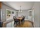 Bright dining room with wood floors, a chandelier, large window view, and glass door entry at 176 Stewart Nw Ave, Marietta, GA 30064