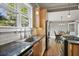 Open kitchen: Window view to dining room and stainless steel appliances at 176 Stewart Nw Ave, Marietta, GA 30064