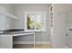 Bright laundry room featuring a countertop workspace and ample storage with a large window at 176 Stewart Nw Ave, Marietta, GA 30064
