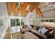 Open concept living room with wood floors, vaulted ceilings, and access to outdoor patio at 176 Stewart Nw Ave, Marietta, GA 30064