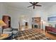 Cozy living room featuring a fireplace, wood floors, ceiling fan, and an area rug at 176 Stewart Nw Ave, Marietta, GA 30064