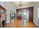 Open-concept living area with hardwood floors, a fireplace, and custom cabinetry, seamlessly connecting living spaces at 176 Stewart Nw Ave, Marietta, GA 30064