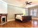 Spacious bedroom features a decorative fireplace, hardwood floors, and a modern ceiling fan at 176 Stewart Nw Ave, Marietta, GA 30064