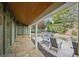 Stone patio overlooking a pool with a rock waterfall surrounded by lush landscaping at 176 Stewart Nw Ave, Marietta, GA 30064