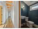 A stylish half bathroom features elegant blue walls, a unique sink, and well-lit space at 176 Stewart Nw Ave, Marietta, GA 30064