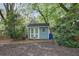Charming backyard shed with double doors and a window, providing extra storage space and functionality at 176 Stewart Nw Ave, Marietta, GA 30064
