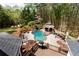 Large in-ground kidney shaped pool and gazebo situated in a wooded backyard with deck access at 1886 Chedworth Ct, Stone Mountain, GA 30087