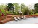 Relaxing backyard patio seating area with lush landscaping and mature trees at 1886 Chedworth Ct, Stone Mountain, GA 30087