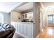 Built-in bar area with white cabinetry, granite countertops, and decorative lighting at 1886 Chedworth Ct, Stone Mountain, GA 30087