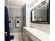 Stylish bathroom featuring marble counters, custom vanity, and a shower with blue curtain at 1886 Chedworth Ct, Stone Mountain, GA 30087