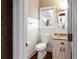 Cozy bathroom with wainscoting, granite countertop vanity, and decorative oval mirror at 1886 Chedworth Ct, Stone Mountain, GA 30087