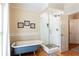 Bathroom featuring a modern bathtub and a glass-door shower with a mosaic floor at 1886 Chedworth Ct, Stone Mountain, GA 30087