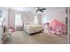 Bright bedroom with pink walls, white metal bed frame and flower accents at 1886 Chedworth Ct, Stone Mountain, GA 30087