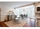 Bright breakfast area with bay windows, elegant chandelier, and a decorative rug at 1886 Chedworth Ct, Stone Mountain, GA 30087