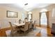 Dining room featuring modern chandelier, neutral walls, and a large window at 1886 Chedworth Ct, Stone Mountain, GA 30087