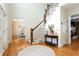 Bright foyer with hardwood floors, staircase, and arched doorway at 1886 Chedworth Ct, Stone Mountain, GA 30087