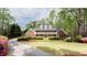 Stately brick home with a beautiful lawn, mature trees and large front porch at 1886 Chedworth Ct, Stone Mountain, GA 30087