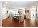 Open kitchen featuring a center island with seating, brick floors and white cabinetry at 1886 Chedworth Ct, Stone Mountain, GA 30087