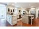 Spacious kitchen with center island, brick flooring, stainless appliances, and granite countertops at 1886 Chedworth Ct, Stone Mountain, GA 30087