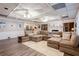 Spacious living room with large sectional sofa, hardwood floors, and ample natural light at 1886 Chedworth Ct, Stone Mountain, GA 30087
