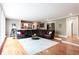 Open-concept living area with hardwood floors, white trim, and adjacent bar area at 1886 Chedworth Ct, Stone Mountain, GA 30087