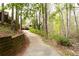 Paved path leading to the home with natural landscaping and retaining wall at 1886 Chedworth Ct, Stone Mountain, GA 30087