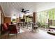 Covered brick patio with comfortable seating, an outdoor TV, and a ceiling fan at 1886 Chedworth Ct, Stone Mountain, GA 30087