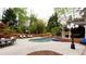 Gorgeous in-ground kidney shaped pool with gazebo, outdoor seating and lush landscaping at 1886 Chedworth Ct, Stone Mountain, GA 30087