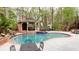 Beautiful in-ground kidney shaped pool with gazebo and hot tub in wooded backyard at 1886 Chedworth Ct, Stone Mountain, GA 30087