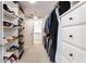 Organized walk-in closet with ample shoe shelving and clothing storage at 1886 Chedworth Ct, Stone Mountain, GA 30087