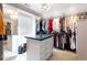 Spacious walk-in closet with custom shelving, hanging racks, and a center island at 1886 Chedworth Ct, Stone Mountain, GA 30087