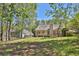 A view of the home's backyard highlighting the well-maintained lawn, deck, and landscaping at 2865 Maple Vista Ln, Lawrenceville, GA 30044