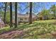 A backyard featuring lush greenery, a charming pergola, and a spacious deck for outdoor enjoyment at 2865 Maple Vista Ln, Lawrenceville, GA 30044