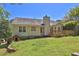 View of the home's backyard, including a wooden deck, shed and well-maintained lawn at 2865 Maple Vista Ln, Lawrenceville, GA 30044