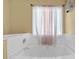 Bathroom featuring a luxurious white tub and a window with elegant curtains at 2865 Maple Vista Ln, Lawrenceville, GA 30044