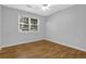 Bedroom with a large window offering natural light and hardwood floors at 2865 Maple Vista Ln, Lawrenceville, GA 30044