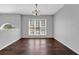 Empty dining room with beautiful wood floors and natural light from a large window at 2865 Maple Vista Ln, Lawrenceville, GA 30044