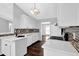 Modern kitchen boasting white cabinetry, quartz countertops, stylish tile backsplash, and gas range at 2865 Maple Vista Ln, Lawrenceville, GA 30044